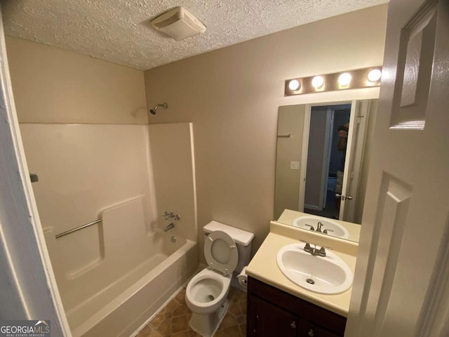 full bathroom featuring a textured ceiling, vanity, shower / tub combination, and toilet