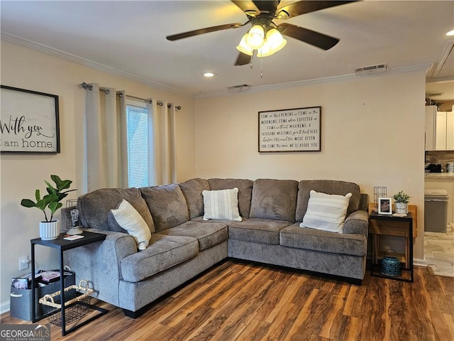 living room featuring ceiling fan, ornamental molding, and wood-type flooring