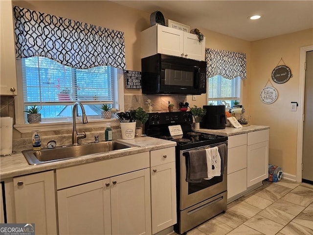 kitchen featuring white cabinetry, tasteful backsplash, sink, and electric range oven