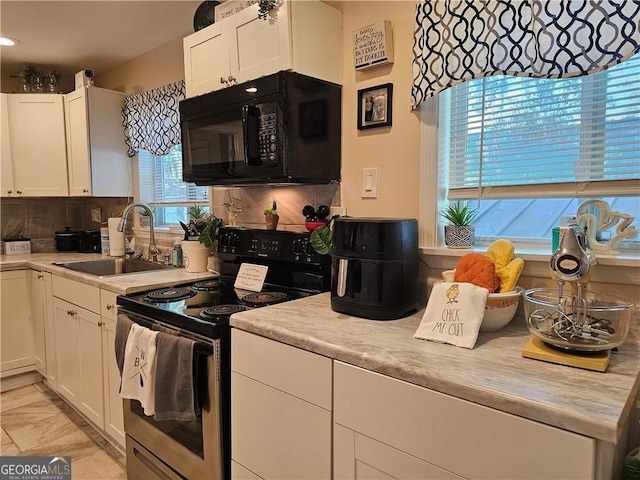 kitchen with white cabinetry, sink, electric range, and backsplash