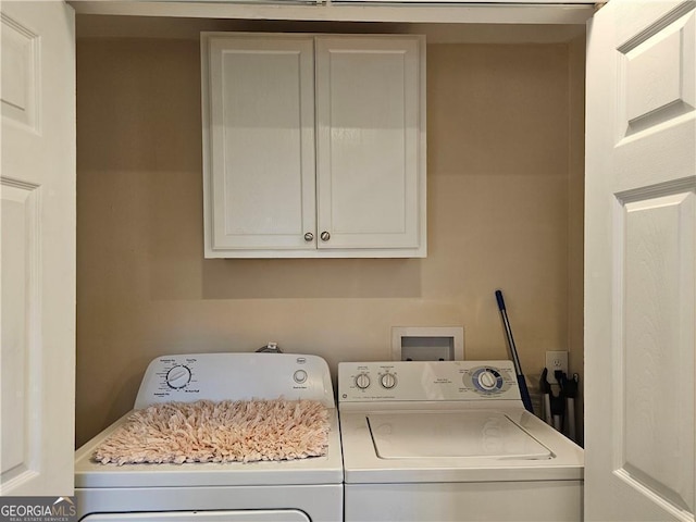 washroom with cabinets and washer and clothes dryer