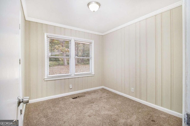 carpeted spare room with crown molding