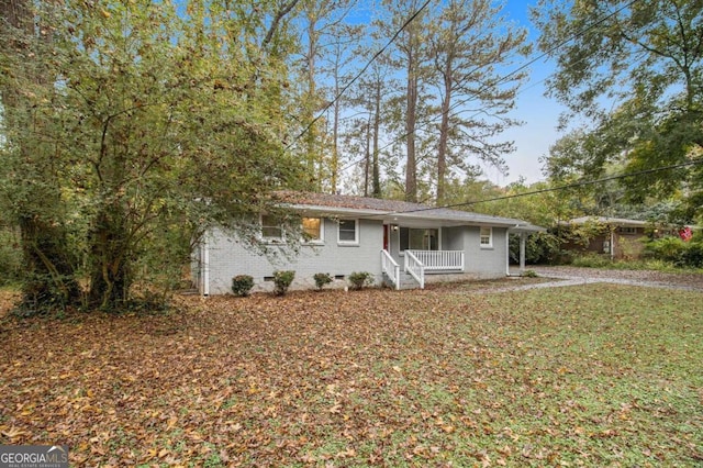 ranch-style home with a porch and a front yard