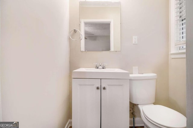 bathroom featuring toilet and vanity