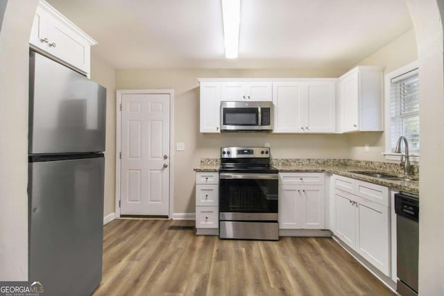 kitchen featuring white cabinets, appliances with stainless steel finishes, and sink