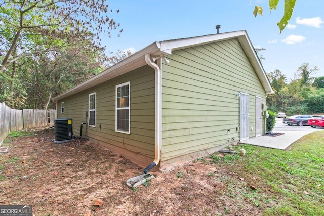 view of property exterior featuring central AC unit and a patio area