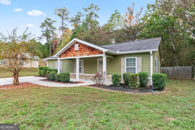 view of front of house with a front yard and covered porch