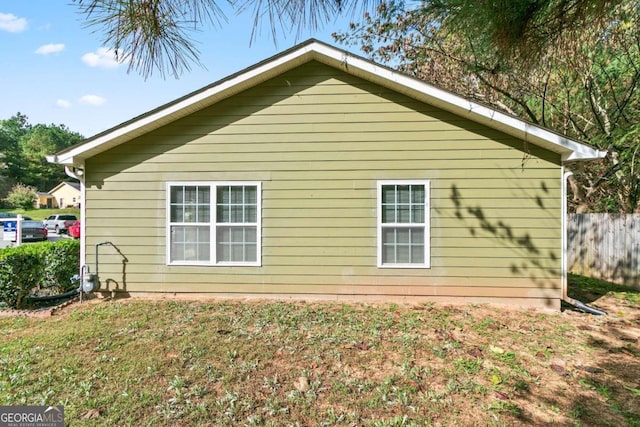 view of property exterior featuring a lawn