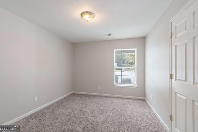 spare room with light colored carpet