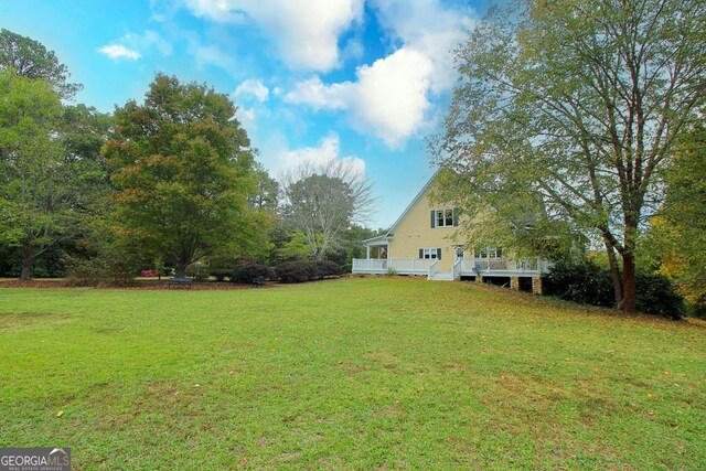 view of yard with a wooden deck