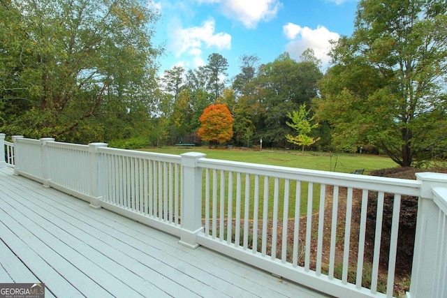 deck with a trampoline and a yard