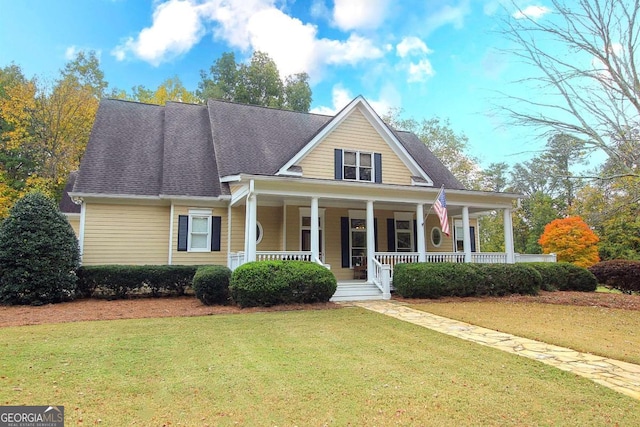 view of front of property featuring covered porch and a front yard