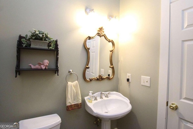 bathroom featuring sink and toilet