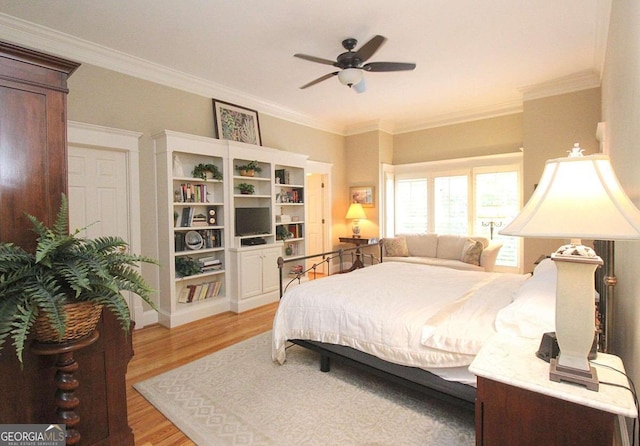 bedroom featuring ornamental molding, ceiling fan, and light hardwood / wood-style flooring