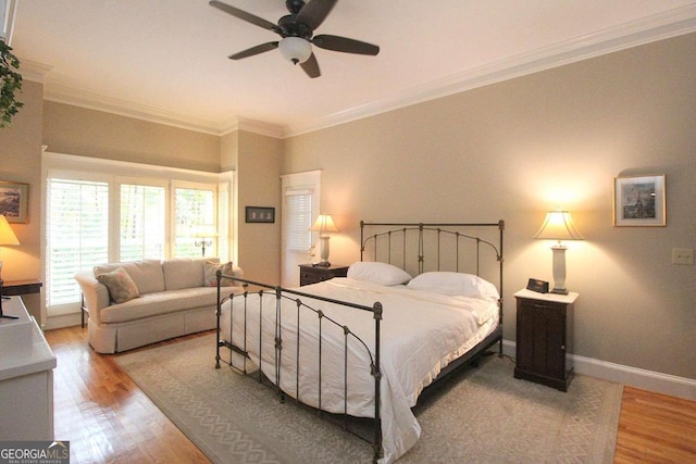 bedroom featuring ornamental molding, light hardwood / wood-style flooring, and ceiling fan