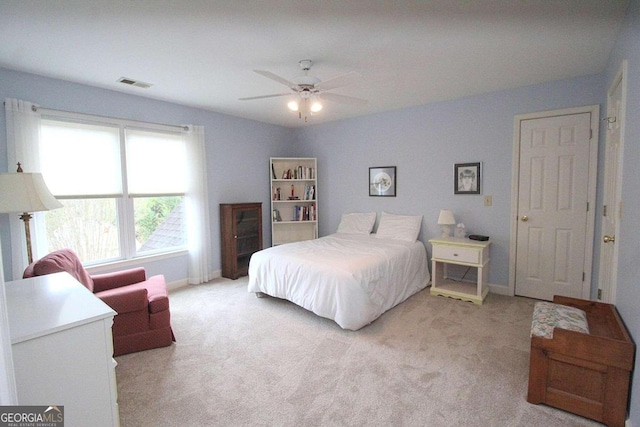 bedroom featuring light carpet and ceiling fan