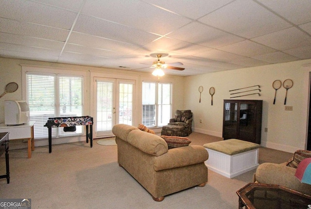 living room featuring a paneled ceiling, carpet, and ceiling fan