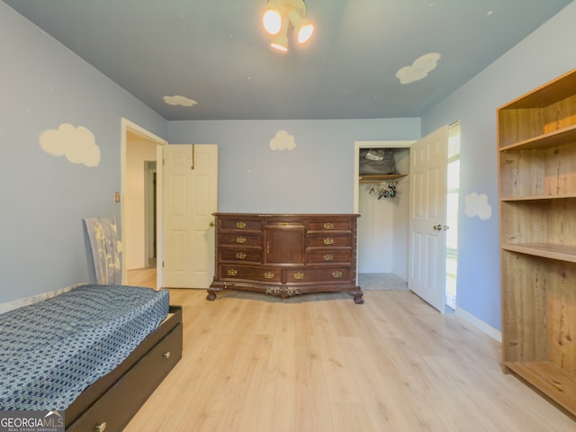 bedroom featuring light hardwood / wood-style floors and a closet