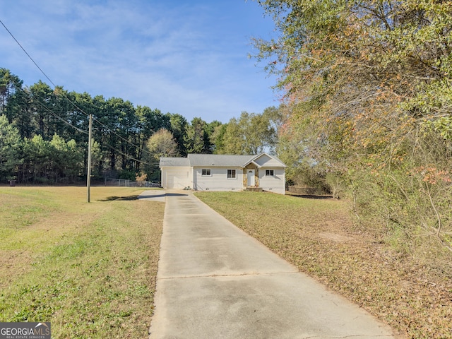 view of front of home with a garage and a front lawn