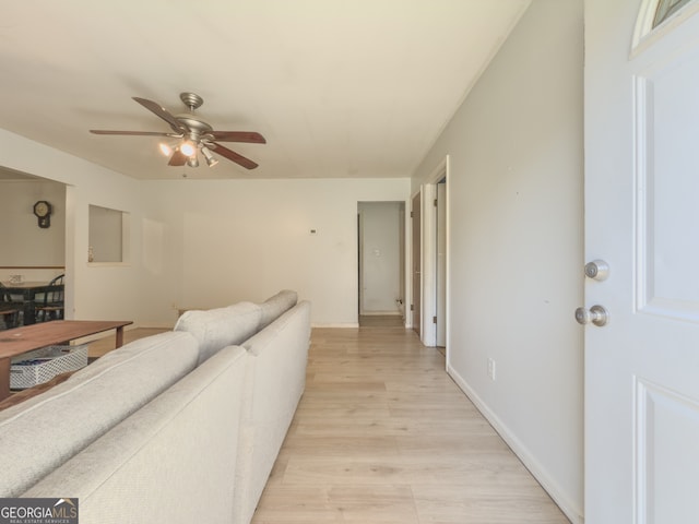 living room featuring ceiling fan and light hardwood / wood-style floors