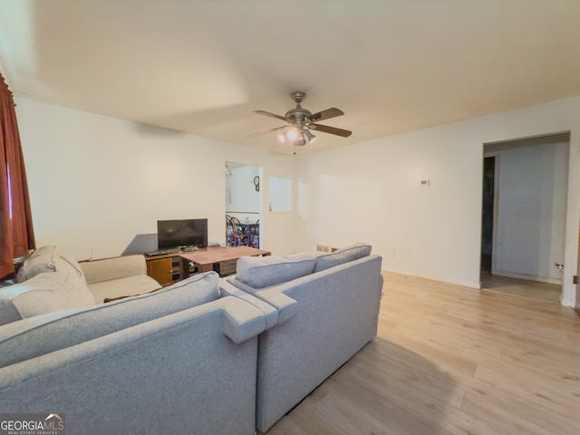 living room with ceiling fan and light hardwood / wood-style floors