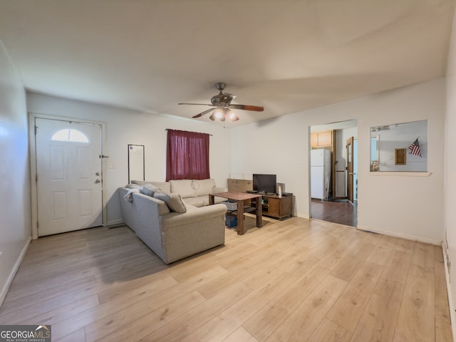 living room featuring ceiling fan and light wood-type flooring