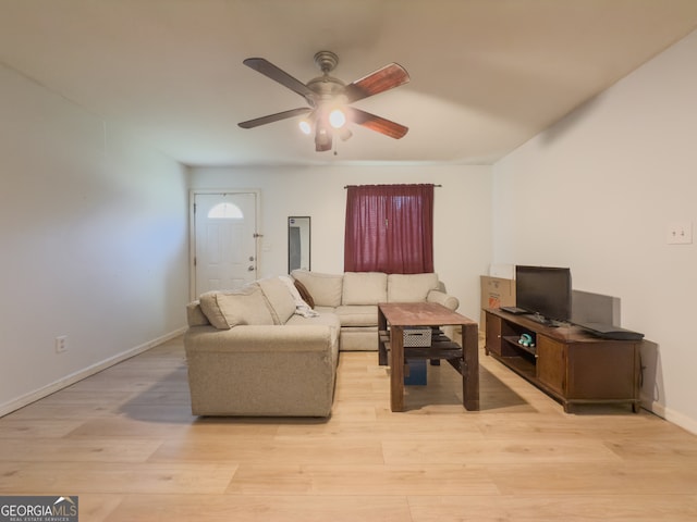 living room featuring ceiling fan and light hardwood / wood-style flooring