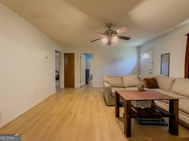 living room with light hardwood / wood-style floors and ceiling fan