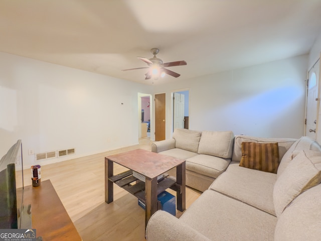 living room featuring light hardwood / wood-style flooring and ceiling fan