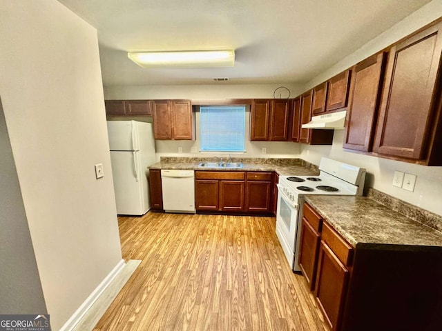 kitchen featuring white appliances, sink, and light wood-type flooring