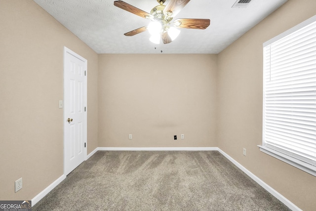 spare room with carpet floors, a textured ceiling, and ceiling fan