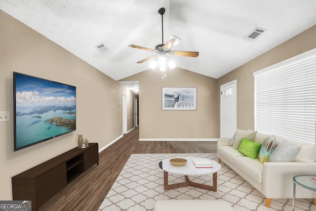 living room with vaulted ceiling, dark hardwood / wood-style floors, and ceiling fan