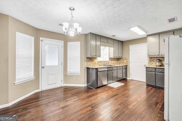 kitchen with pendant lighting, gray cabinets, dark hardwood / wood-style floors, white refrigerator, and stainless steel dishwasher