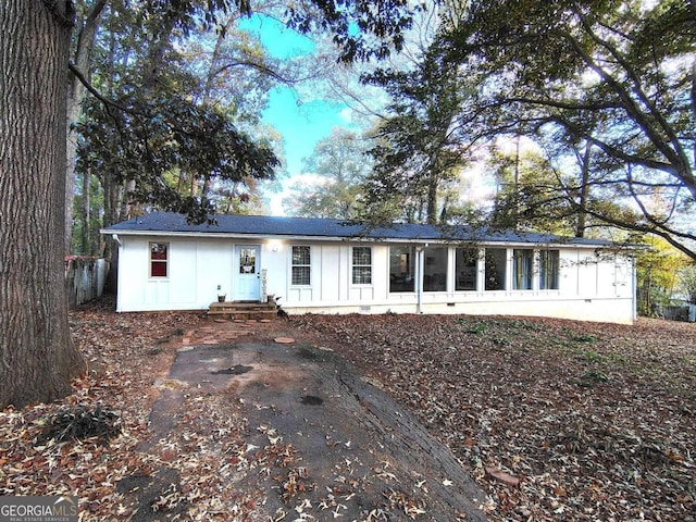 single story home featuring board and batten siding and entry steps