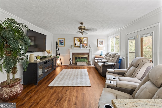 living room featuring dark hardwood / wood-style flooring, crown molding, and a brick fireplace