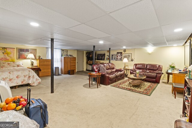 interior space featuring light colored carpet and a drop ceiling