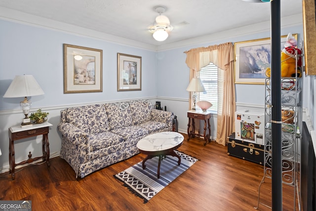 living room featuring hardwood / wood-style flooring, ceiling fan, and crown molding