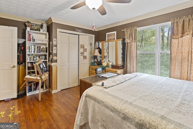 bedroom featuring ornamental molding, ceiling fan, a textured ceiling, a closet, and dark hardwood / wood-style flooring