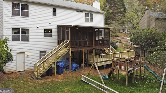 back of house with a sunroom and a wooden deck