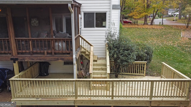 wooden deck featuring a yard