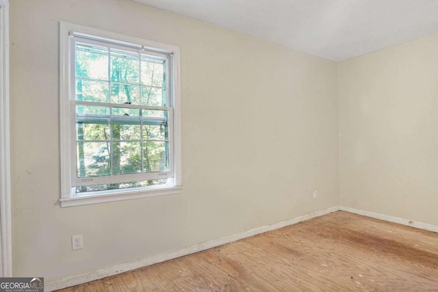 spare room with hardwood / wood-style flooring