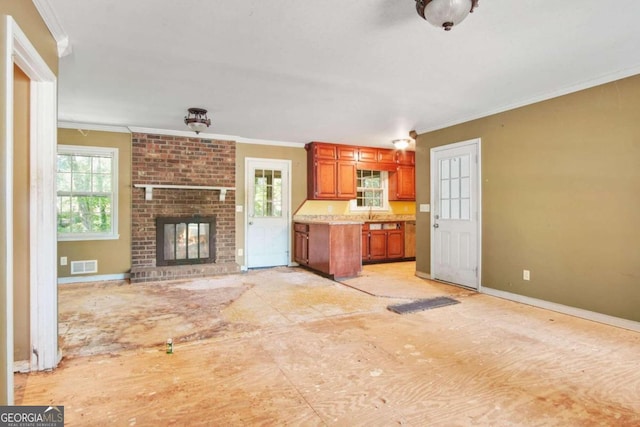 unfurnished living room with a fireplace and crown molding