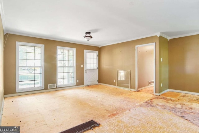 unfurnished room with crown molding