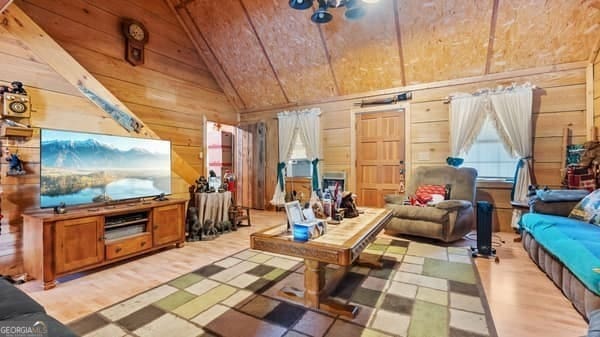 287 Branch Rd, Cedartown, GA 30125 - living room featuring lofted ceiling, wood walls, and wooden ceiling