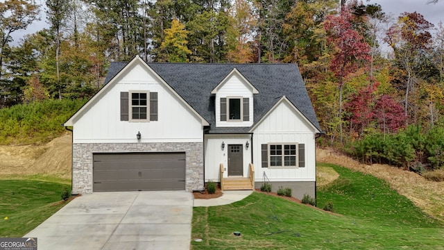 modern inspired farmhouse featuring a front lawn and a garage