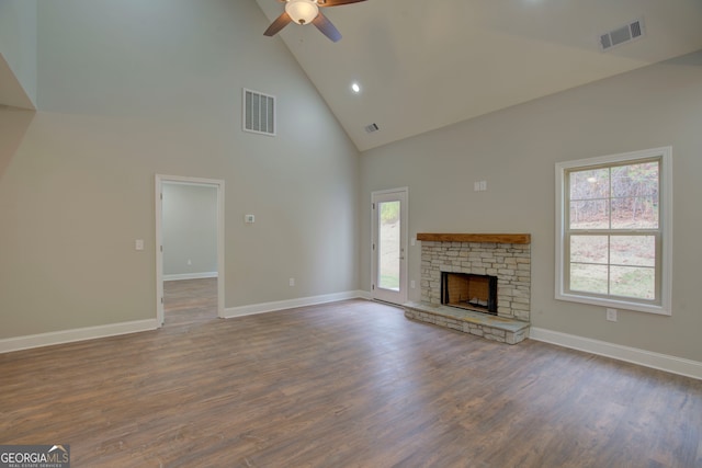 unfurnished living room with high vaulted ceiling, dark hardwood / wood-style flooring, ceiling fan, and a fireplace