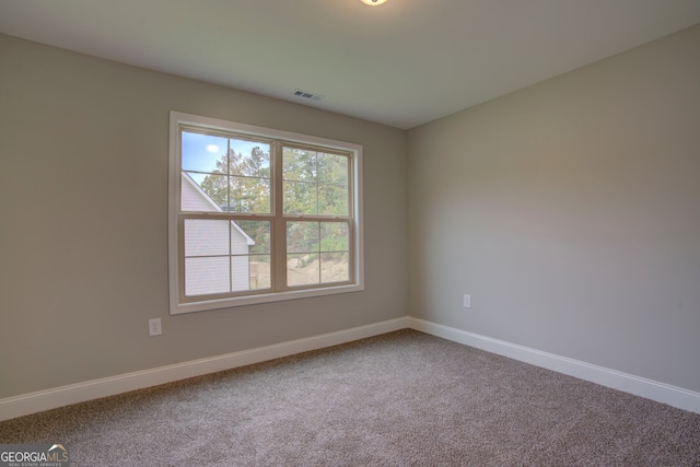 spare room featuring carpet