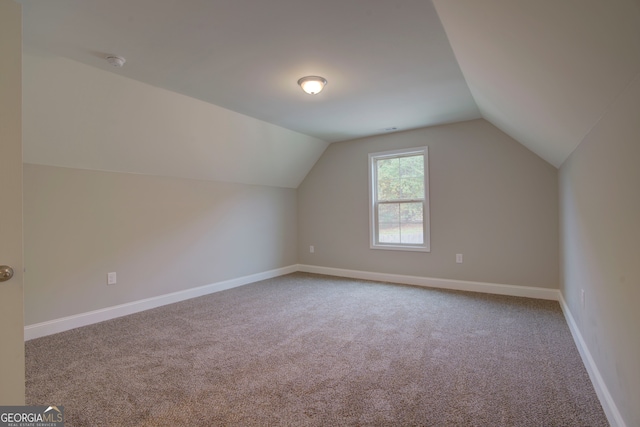 bonus room featuring lofted ceiling and carpet