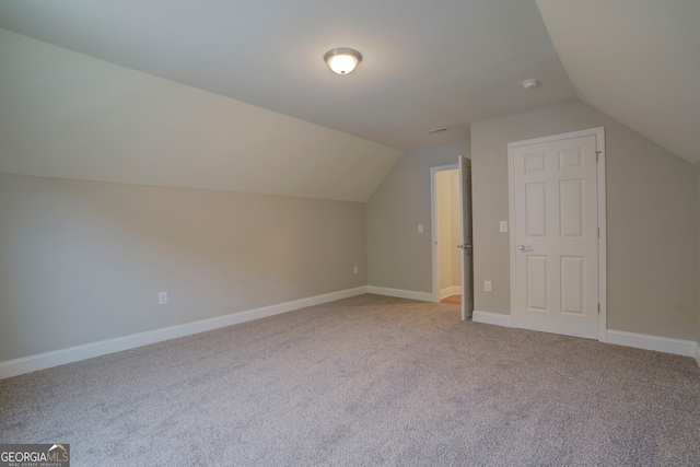 bonus room featuring light carpet and lofted ceiling