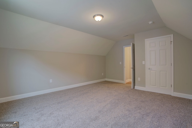 bonus room featuring light colored carpet and lofted ceiling